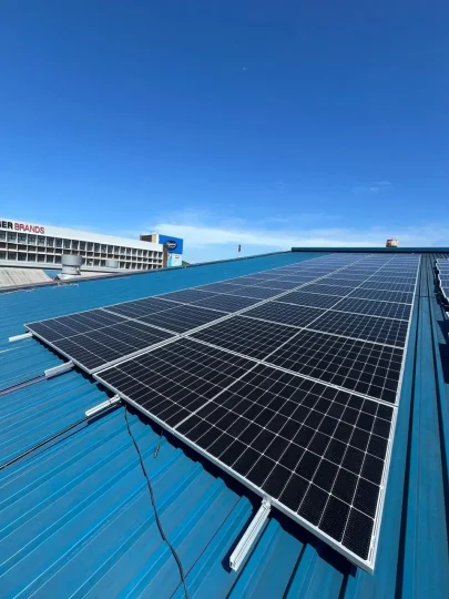 Solar panels mounted on rails on a corrugated metal roof