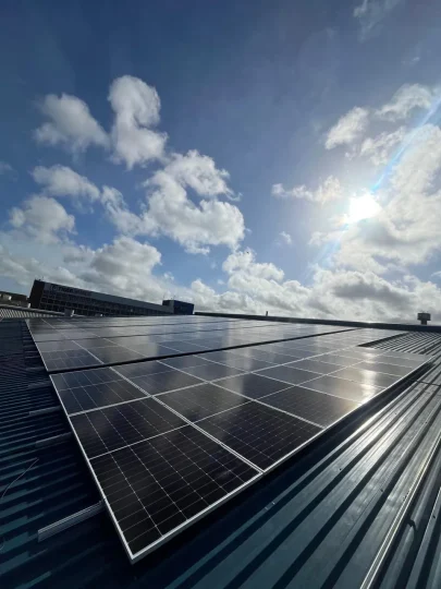 Rooftop solar panels in bright sunlight, where real-world output depends on conditions as well as panel rating